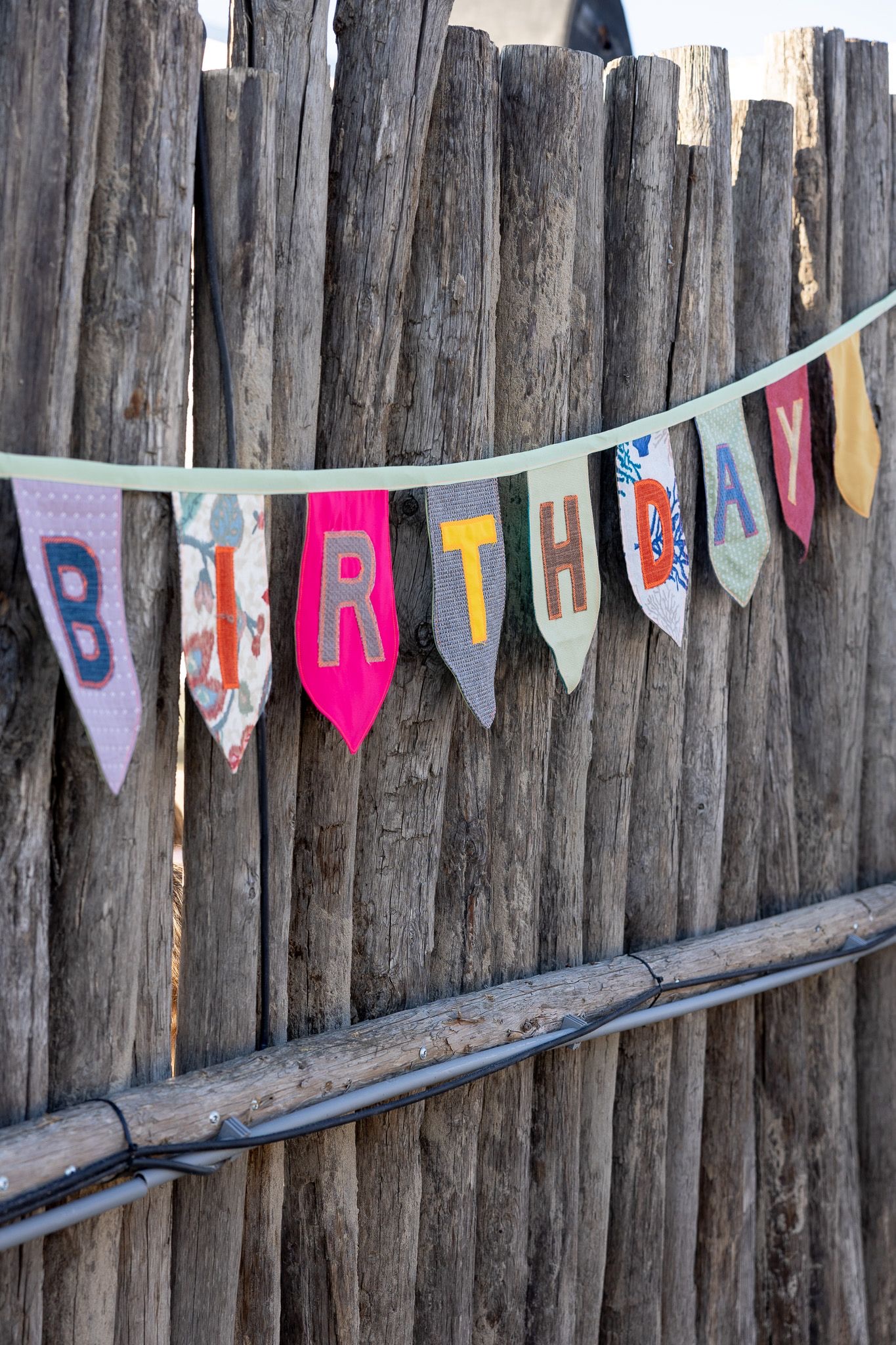 Birthday bunting on a wooden fence