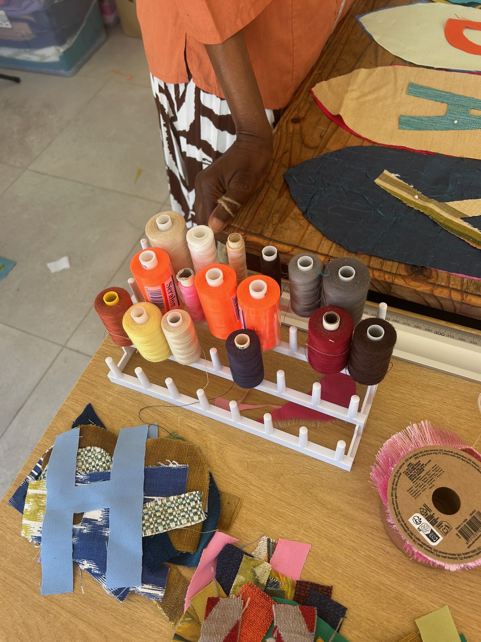 A rack of thread spools, orange in the middle